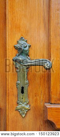 The iron doorhandle on the wooden doors