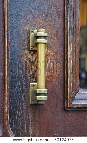 The iron doorhandle on the wooden doors