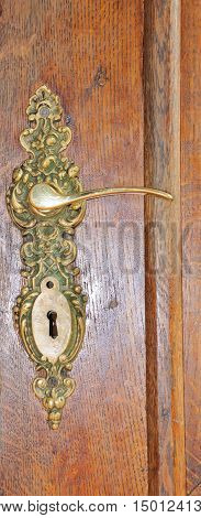 The iron doorhandle on the wooden doors