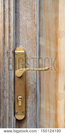 The iron doorhandle on the wooden doors