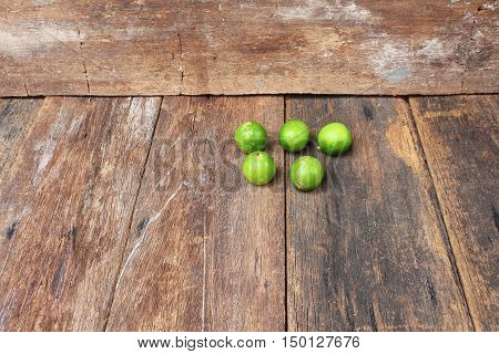 lemon with green on the wooden table top view