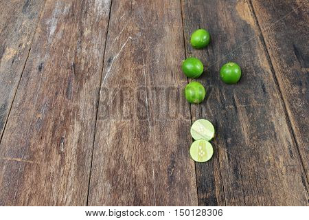 lemon fresh green and slice lime on wooden table top view