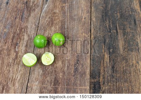 lemon fresh green and slice lime on wooden table top view