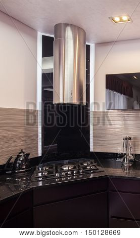 Dark Kitchen With Chromed Hood