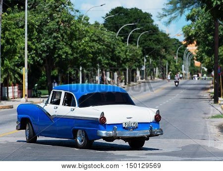 Varadero, Cuba - September 11, 2016:  blue American Classic Car Dirves in Varadero City, Cuba