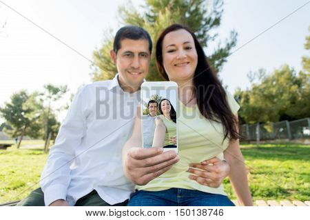 young couple malking autoportrait in the country