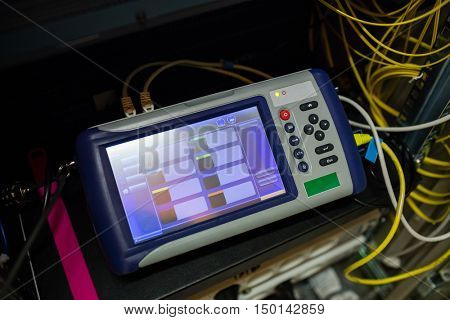 Close-up of digital cable analyzer in server room