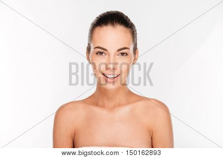 Beauty portrait of a pretty woman with fresh skin looking at camera isolated on a white background