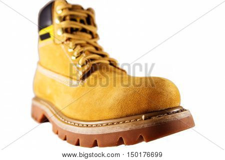 Large yellow shoes with rough soles and laces on a white background