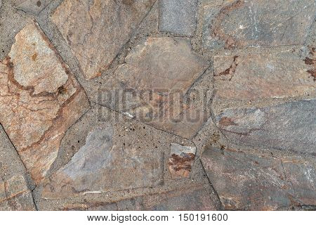 the abstract textured background or wallpaper from a shapeless stone tile