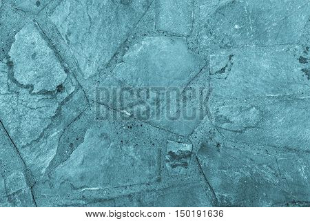 the abstract textured background or wallpaper of blue color from a shapeless stone tile