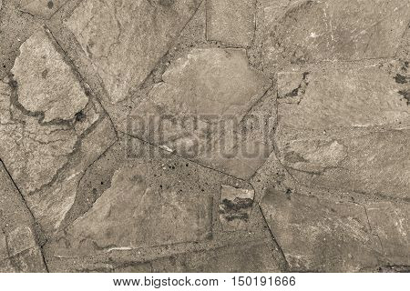the abstract textured background or wallpaper of beige color from a shapeless stone tile
