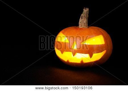 Scary jack o lantern isolated on black. Studio shot