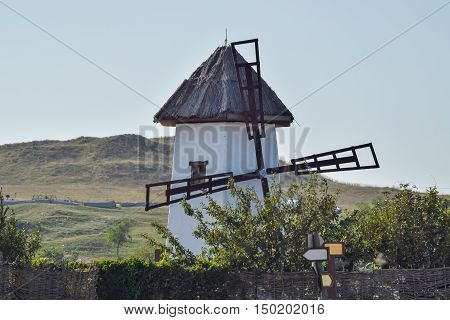 Old Stone Mill With A Thatched Roof