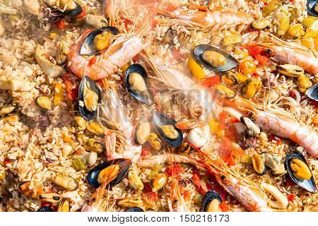 Preparing Paella Rice And Fish