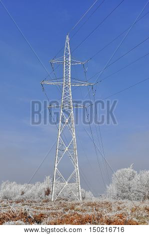 Frozen high voltage power pole in the winter time.