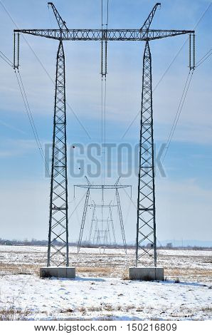 Silhouette of international electrical power line view. Electrical power lines and pylons.