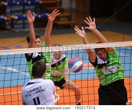 KAPOSVAR, HUNGARY - SEPTEMBER 30: Tamas Vajda (in right) in action at a Hungarian National Championship volleyball game Kaposvar (green) vs. PEAC (white), September 30, 2016 in Kaposvar, Hungary.