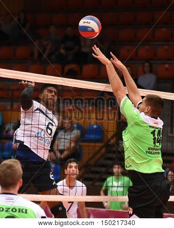 KAPOSVAR, HUNGARY - SEPTEMBER 30: Tamas Vajda (in green) in action at a Hungarian National Championship volleyball game Kaposvar (green) vs. PEAC (white), September 30, 2016 in Kaposvar, Hungary.