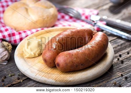 Boiled Sausages On Rustic Round Wooden Board