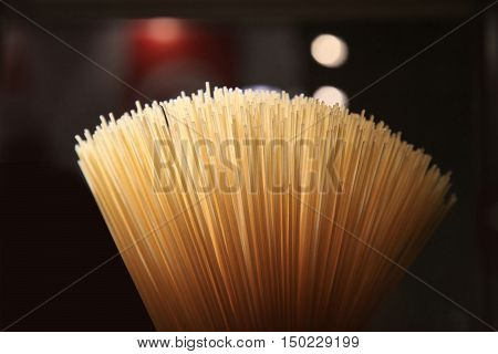Yellow long spaghetti. Yellow italian pasta. Long spaghetti. Raw spaghetti bolognese.