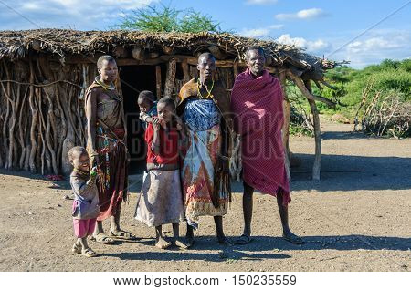 LAKE EYASI, TANZANIA - MAY 29, 2015: A Datoga family in front of their home at Lake Eyasi Tanzania