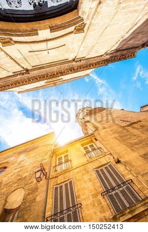 View from below on the church of Holy Espirit on the narrow street in Aix-en-Provence in France