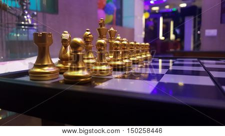 Closeup shot of chess golden piecses in fourground