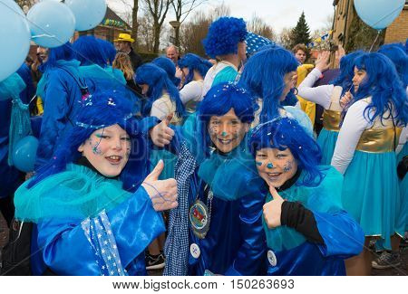 OLDENZAAL NETHERLANDS - FEBRUARY 7 2016: Unknown children with blue hairpieces joining the annual carnival parade