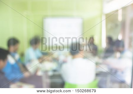 Blurred Business man making a presentation at office. Business executive delivering a presentation to his colleagues during meeting business training explaining business plans to his employees.