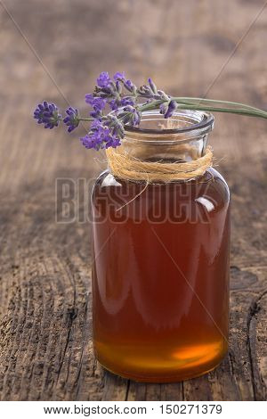 Bio herbal honey in jar with fresh flower