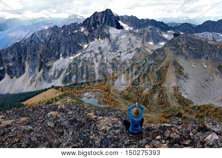 Woman meditating on mountain top. Frosty Mountain. Manning Provincial Park. Hope. British Columbia. Canada.