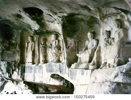 Ancient Tang Dynasty Buddhist sculptures carved in the wall of the Thousand Buddha Cave in Guilin, China, circa 1987.