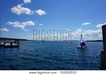 HARBOR SPRINGS, MICHIGAN / UNITED STATES - AUGUST 1, 2016: People enjoy a sailing lesson, provided by Little Traverse Sailors, near the Harbor Springs Yacht Basin.