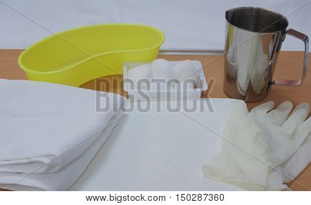 Flushing set for perineal care of patient on desk in hospital.