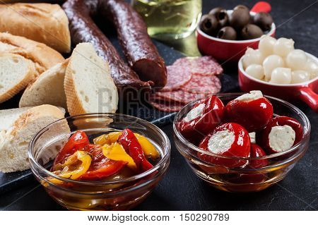 Spanish Tapas With Slices Jamon Serrano And Grilled Pepper. Also Olives, Salami, Pickled Onions, And