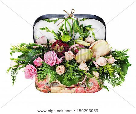 Colorful floral arrangement of roses and lilies in acardboard chest isolated on white background.
