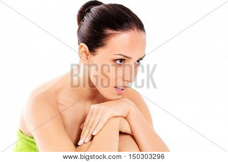 Beautiful woman in towel sitting on the floor