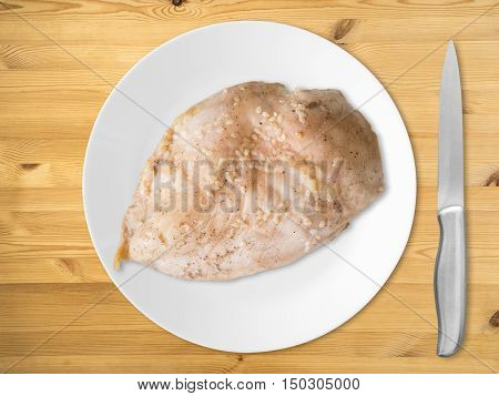 Boiled chicken breast with knife ready to eat. Clean protien food.