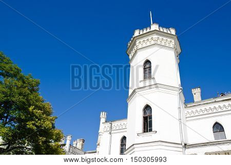 The White Swan palace on blue sky in Sharovka Ukraine
