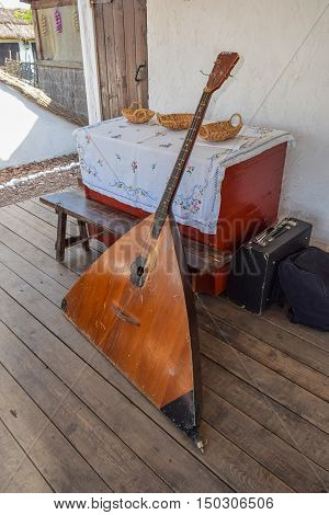Balalaika-contrabass Under A Canopy In A Cottage