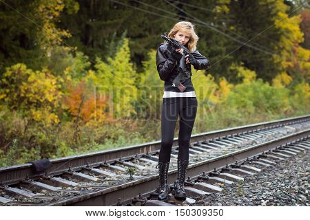 Girl With Arms On The Rails In Autumn Day