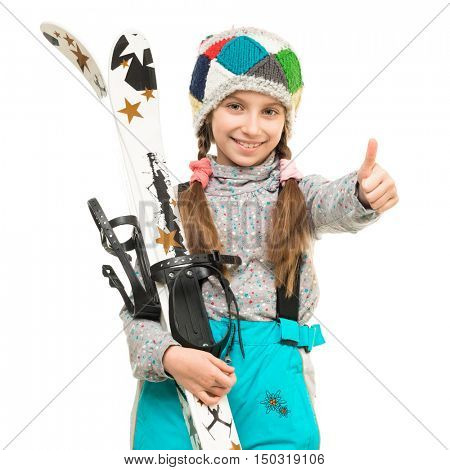 smiling little girl holding skis with thimb up isolated on white background