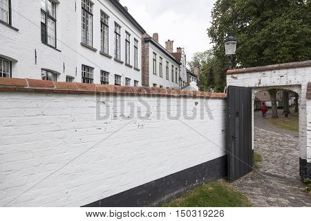 white painted wall of beguinage in flemish city of Bruges in belgium