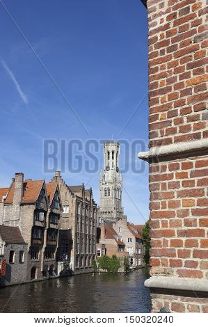 Bruges, Belgium, 28 august 2016: old houses along canal in centre of medieval Brugge in Belgium with blue sky in summer