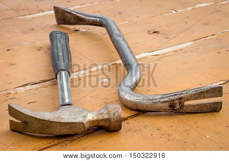 hammer and nail catcher lie on a table