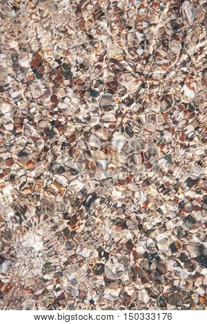 sea pebble on beach and sea water - nature background