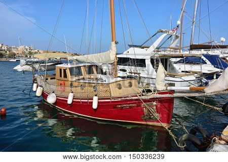 Lavrion Greece - Sept 18 2016: Vintage red sailing yacht moored in marina. Greece very popular place of destination for spending time during vacation