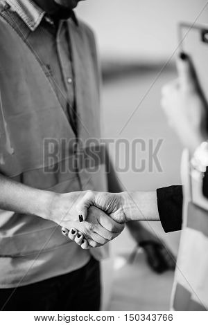 Architects handhaking after successful meeting on construction site