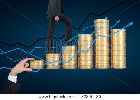 Man in suit is climbing stacks of coins. Giant hand is measuring them. Graphs at the foreground. Dark blue background. Concept of earning money